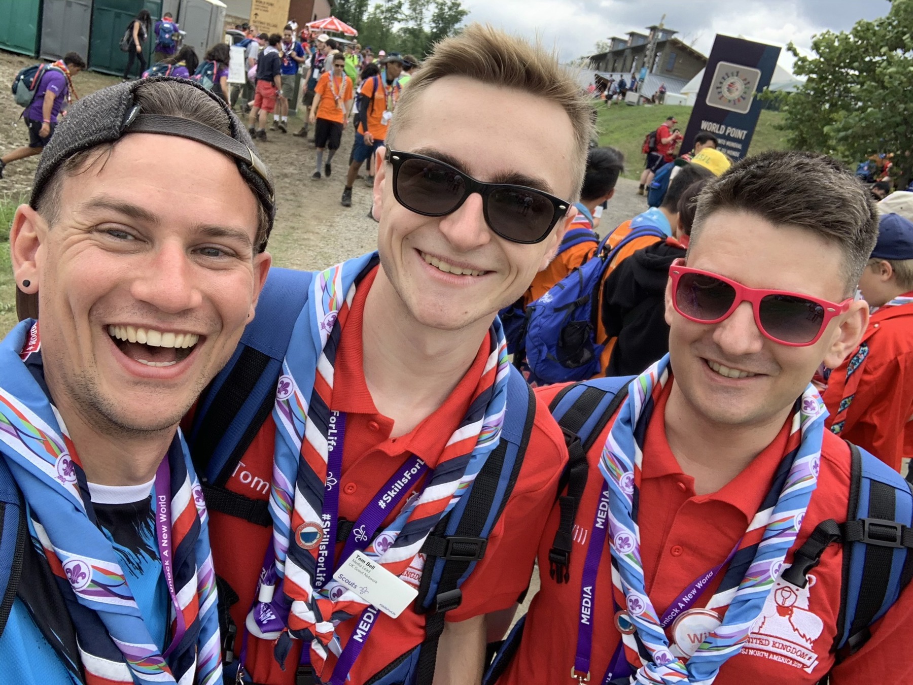 Three male volunteers taking a selfie at the World Scout Jamboree
