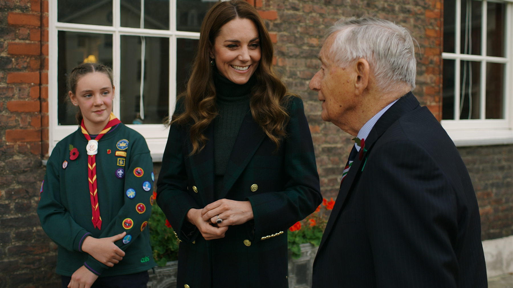 HRH The Duchess of Cambridge smiles talking to Cub Scout Emily Edge and Colonel David Blum OBE