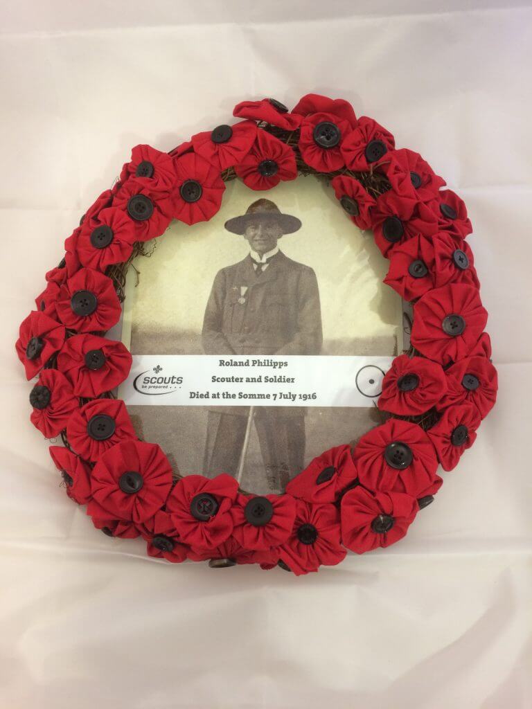 Image shows a picture of Philipps surrounded by a wreath of poppies