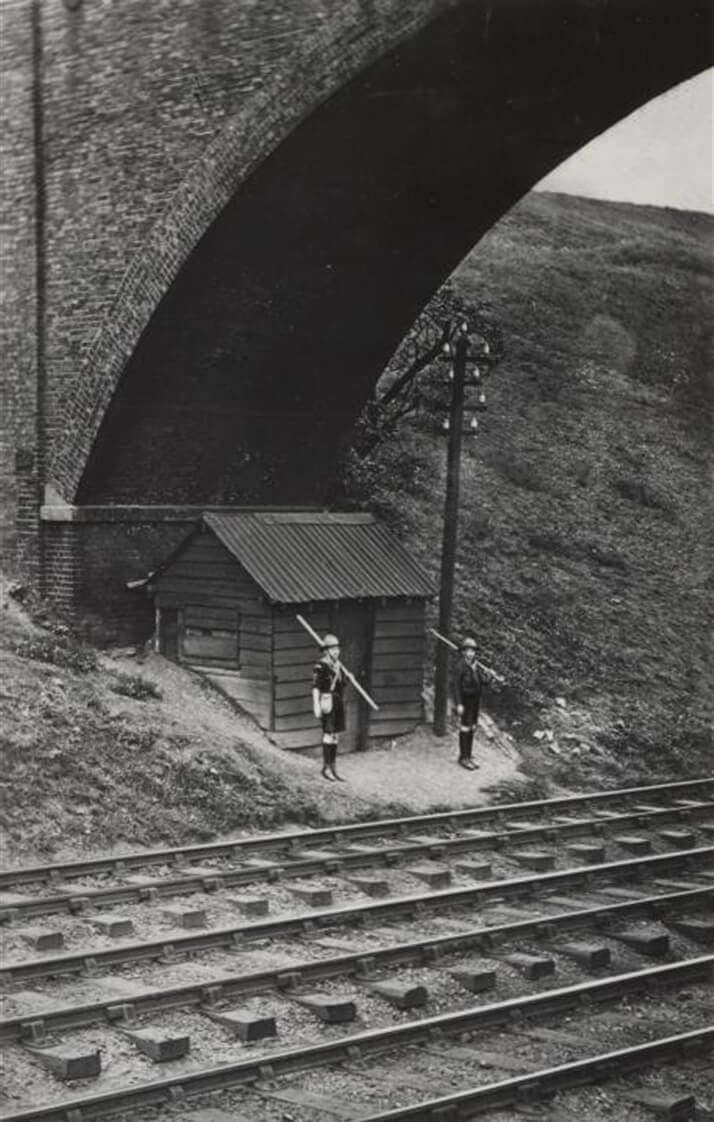 Image shows two Scouts under a rail bridge guarding the railway lines