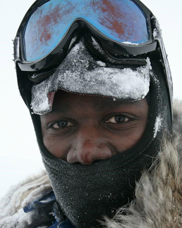 An icy Dwayne Fields with mask, goggles and warm coat looks at the camera