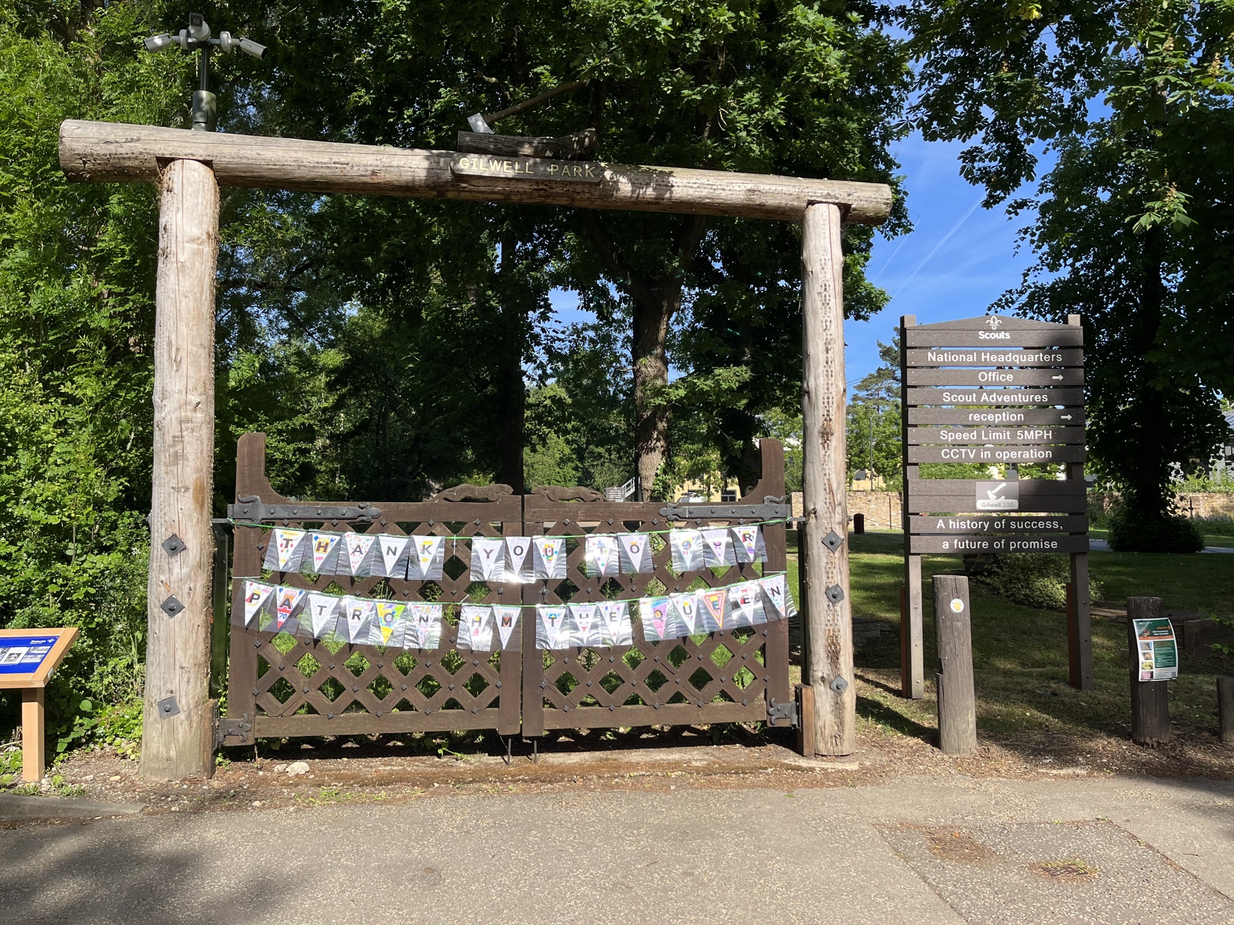 Bunting hanging outside on Leopard Gate at Gilwell Park, reading Thank You To Our Patron HM The Queen
