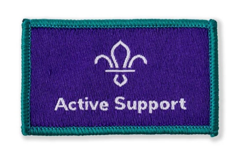 Blue cloth badge with 'Active Support' written in white thread and a white Scouts logo