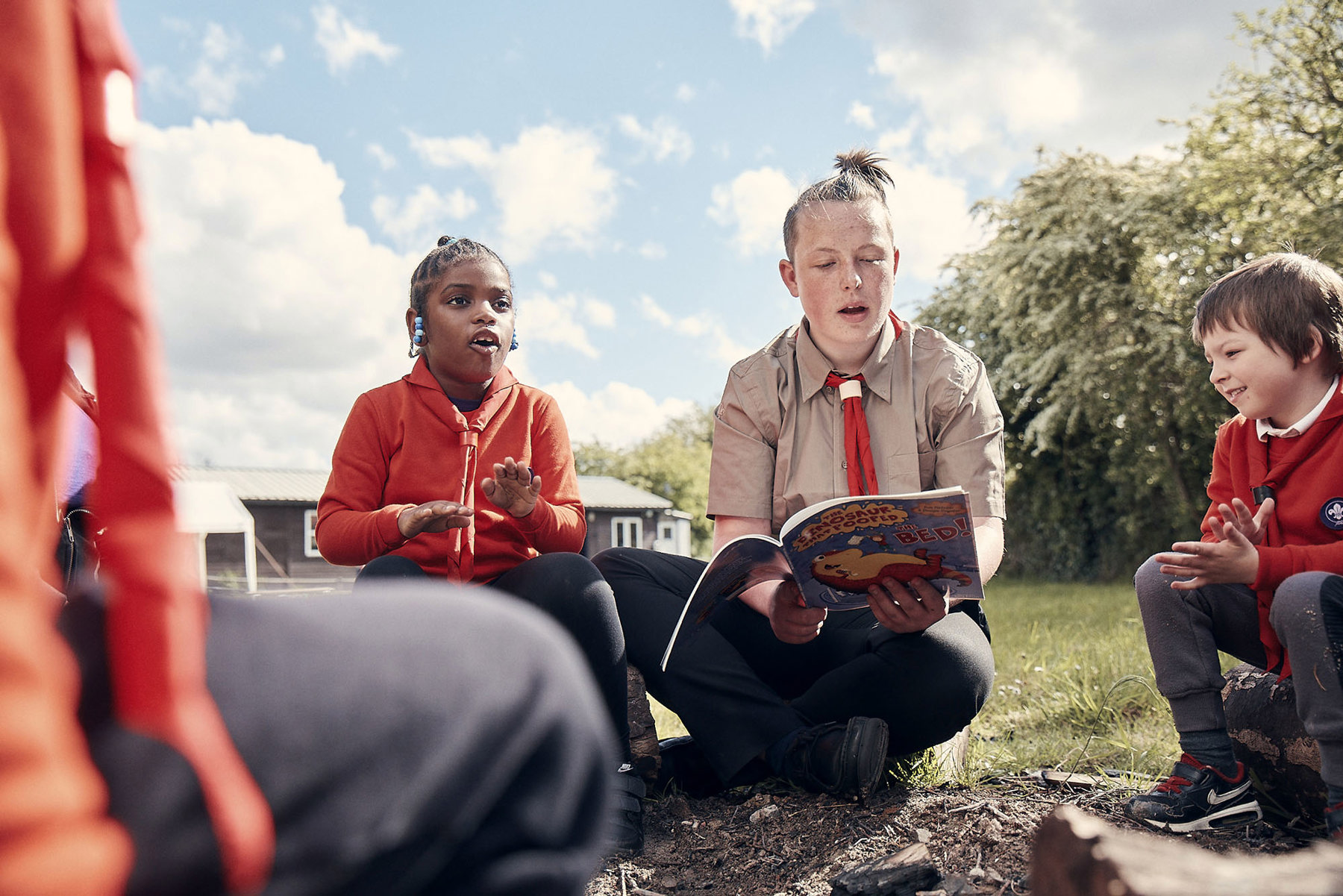 Young leader reading a Squirrels story to young people