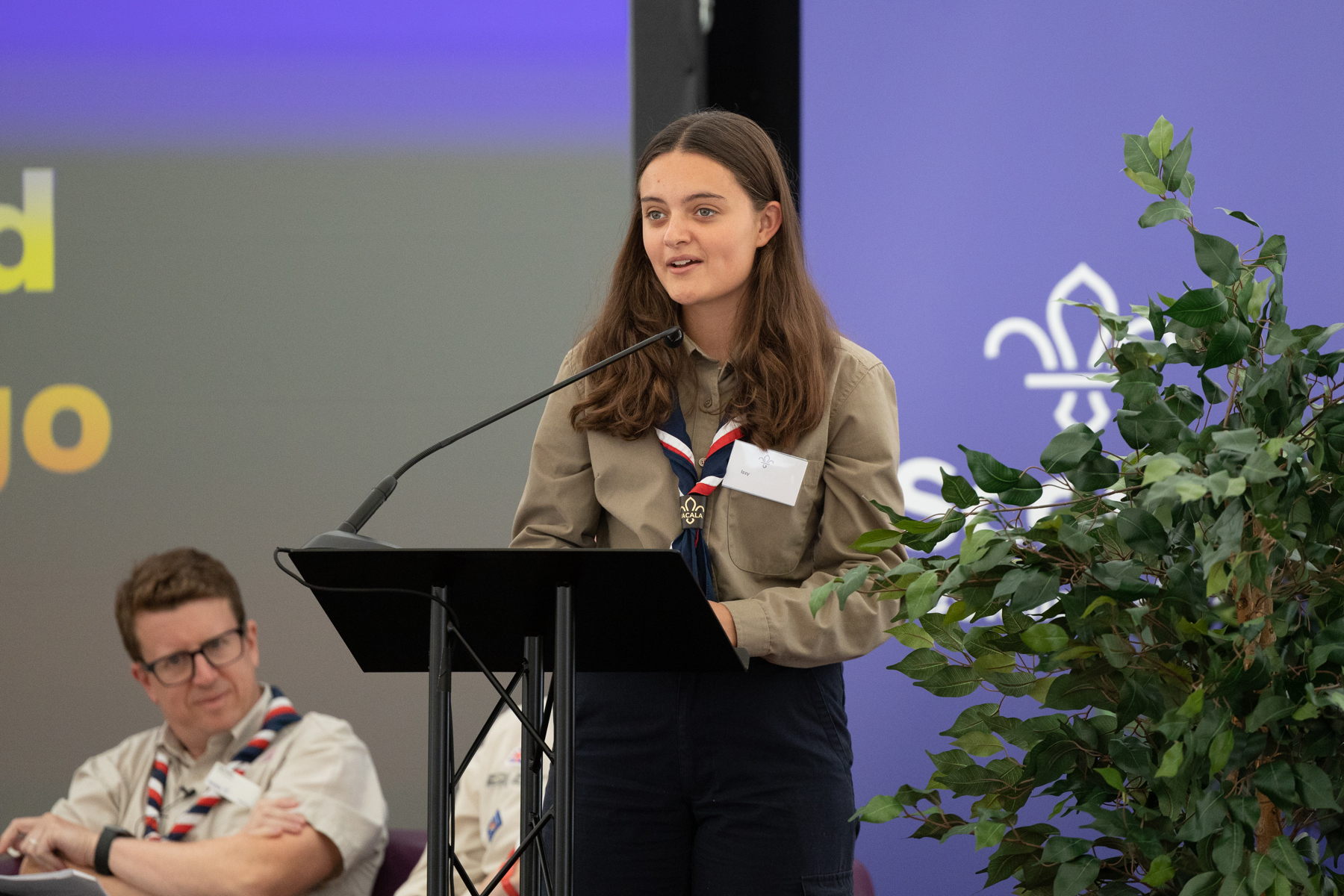 Izzy delivers her speech at Scouts' AGM as Scouts' CEO Matt Hyde watches on