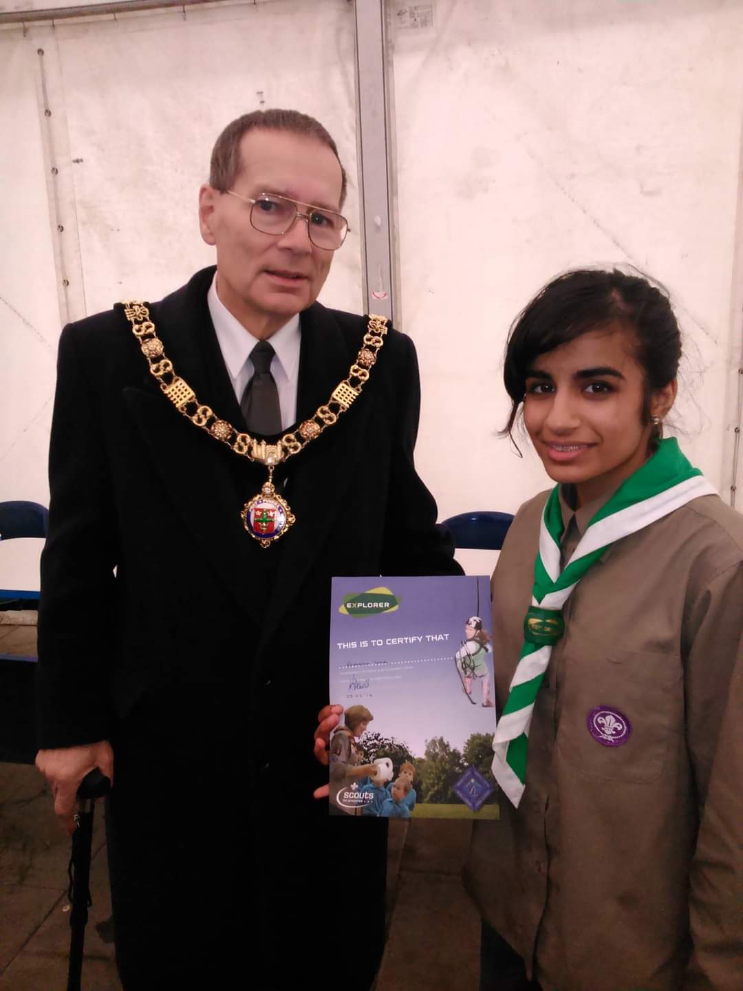 Rehneesa, in Scouts uniform, is presented with an Explorers award.
