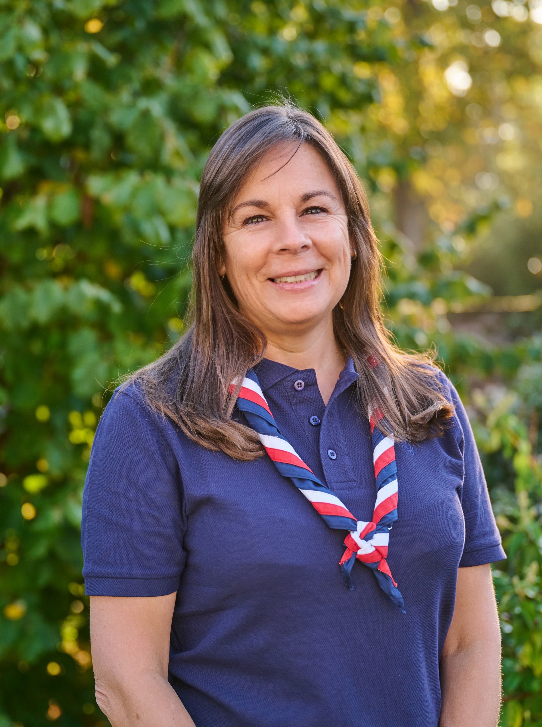 Elizabeth Henderson, Interim Chief Commissioner of England,  in a blue, white and red necker at Gilwell Park