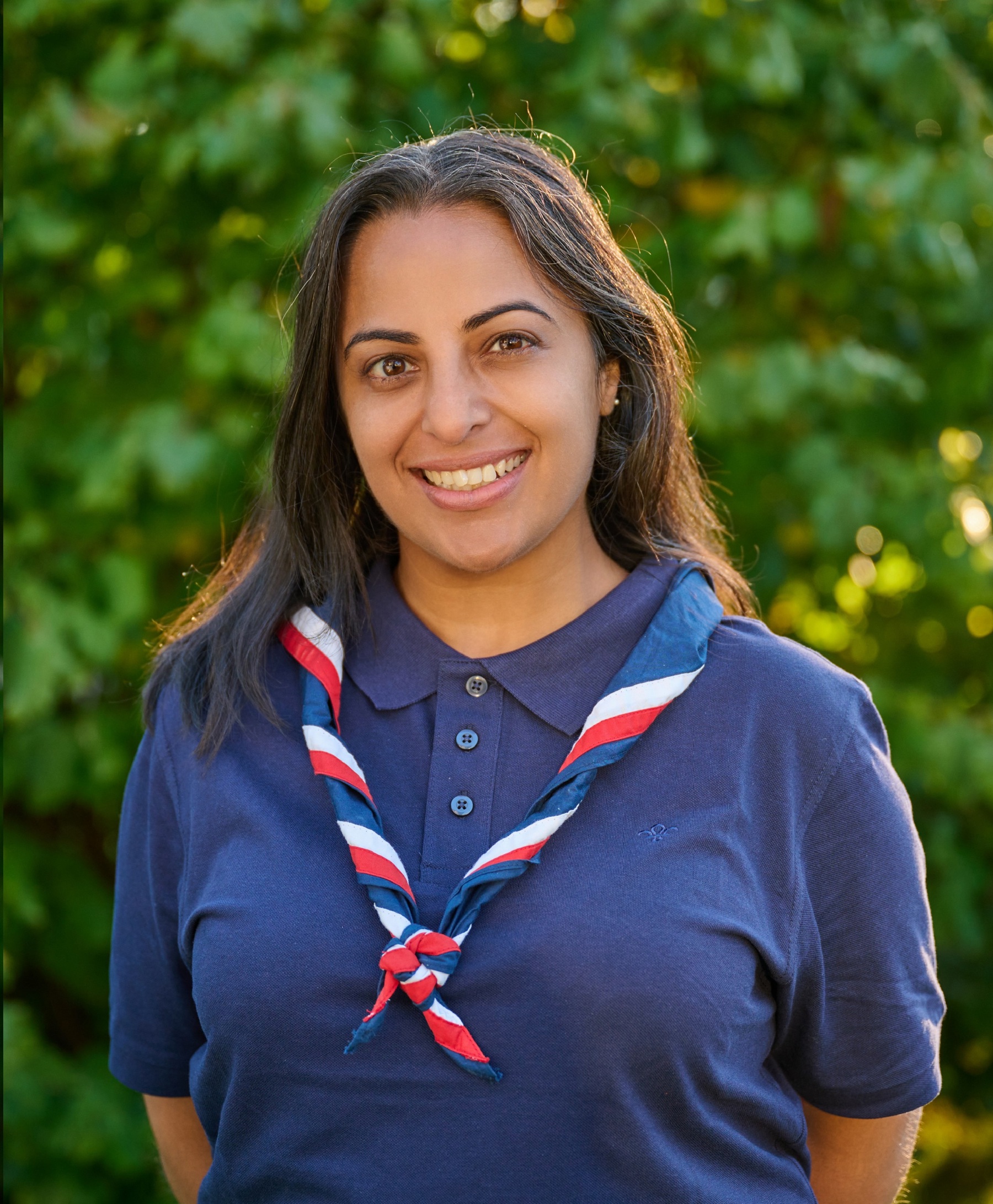 Nisha Patel, UK Commissioner for Perception, in a blue, white and red necker at Gilwell Park
