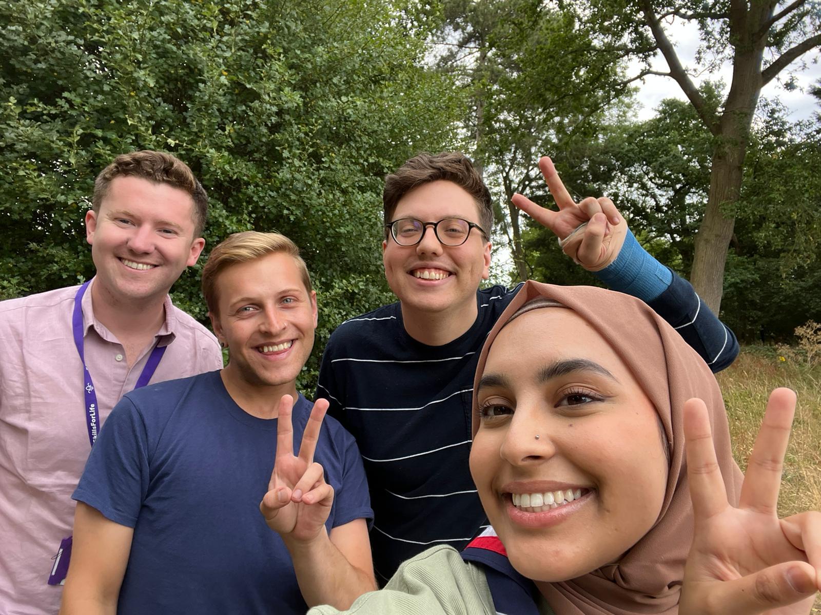 Ayesha and our youth commissioners have taken a selfie. They are all smiling and are showing peace signs with their hands.