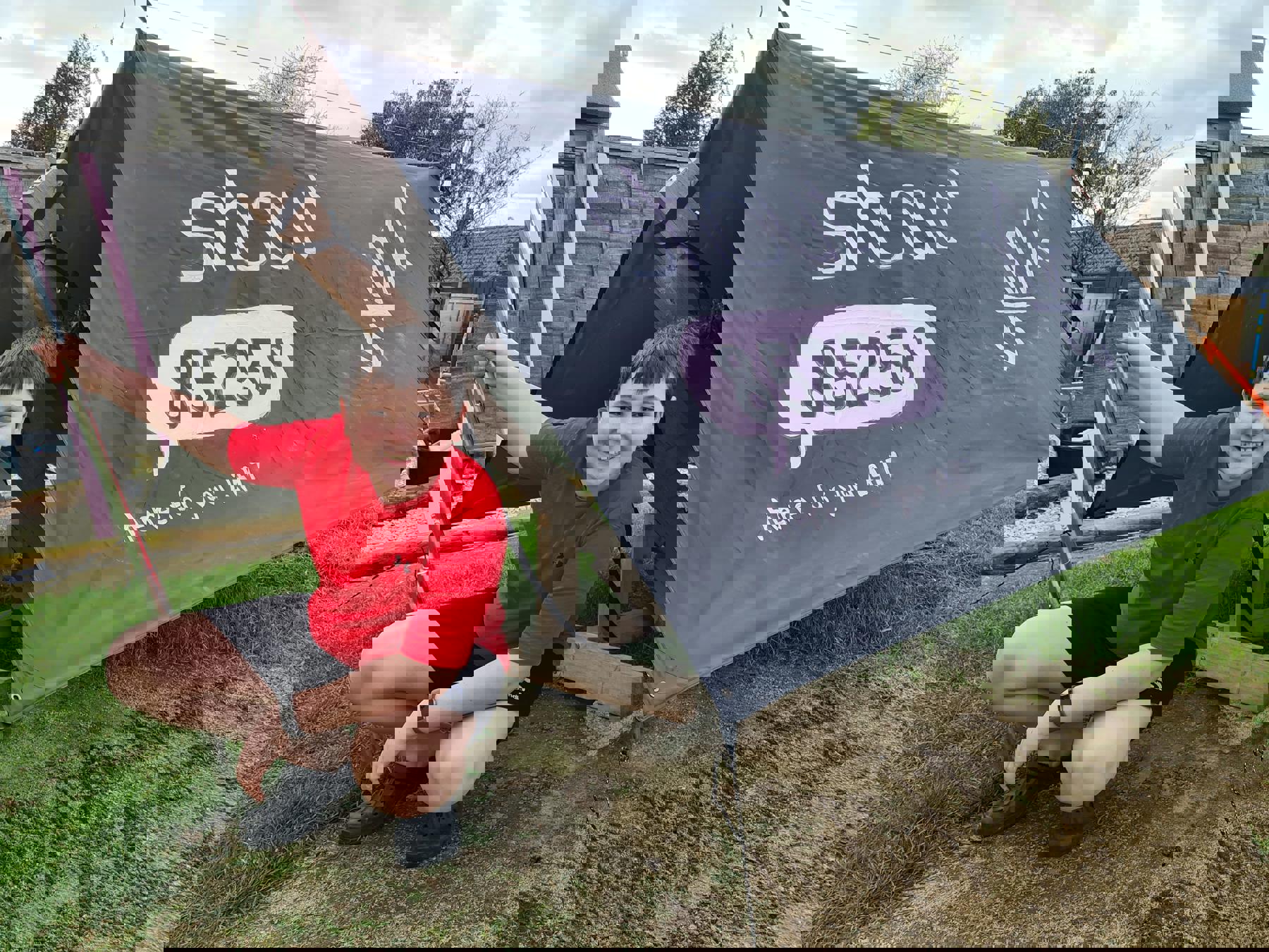Leo sat outside his tent, which has Shout's logo and the Fleur De Lis painted on the outside.