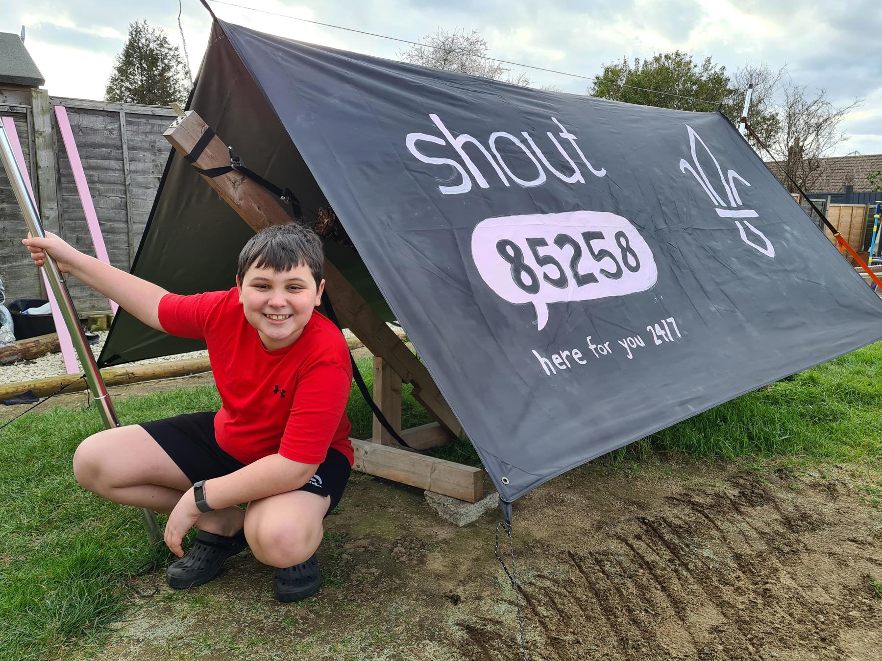 Leo sat outside his tent, which has Shout's logo and the Fleur De Lis painted on the outside.