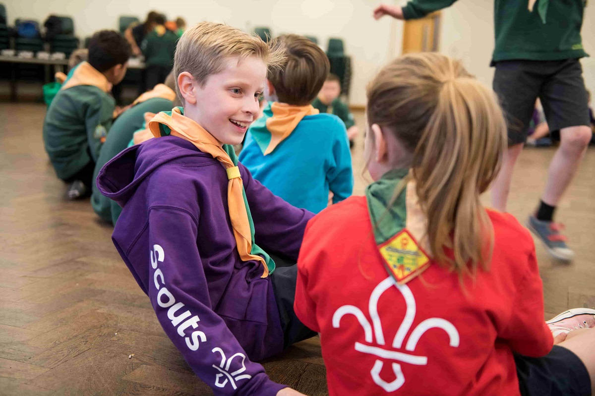 Two cub scouts having a conversation