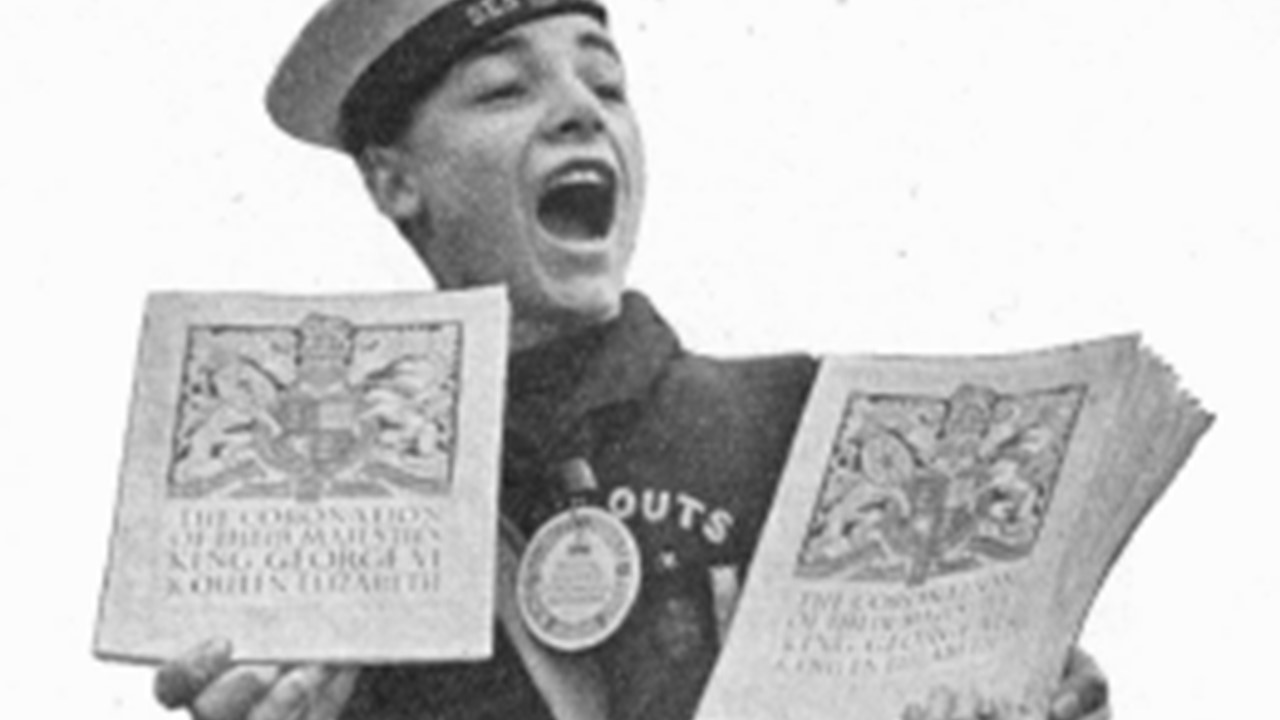 Black and white photo of Scout selling programmes for the 1937 Coronation