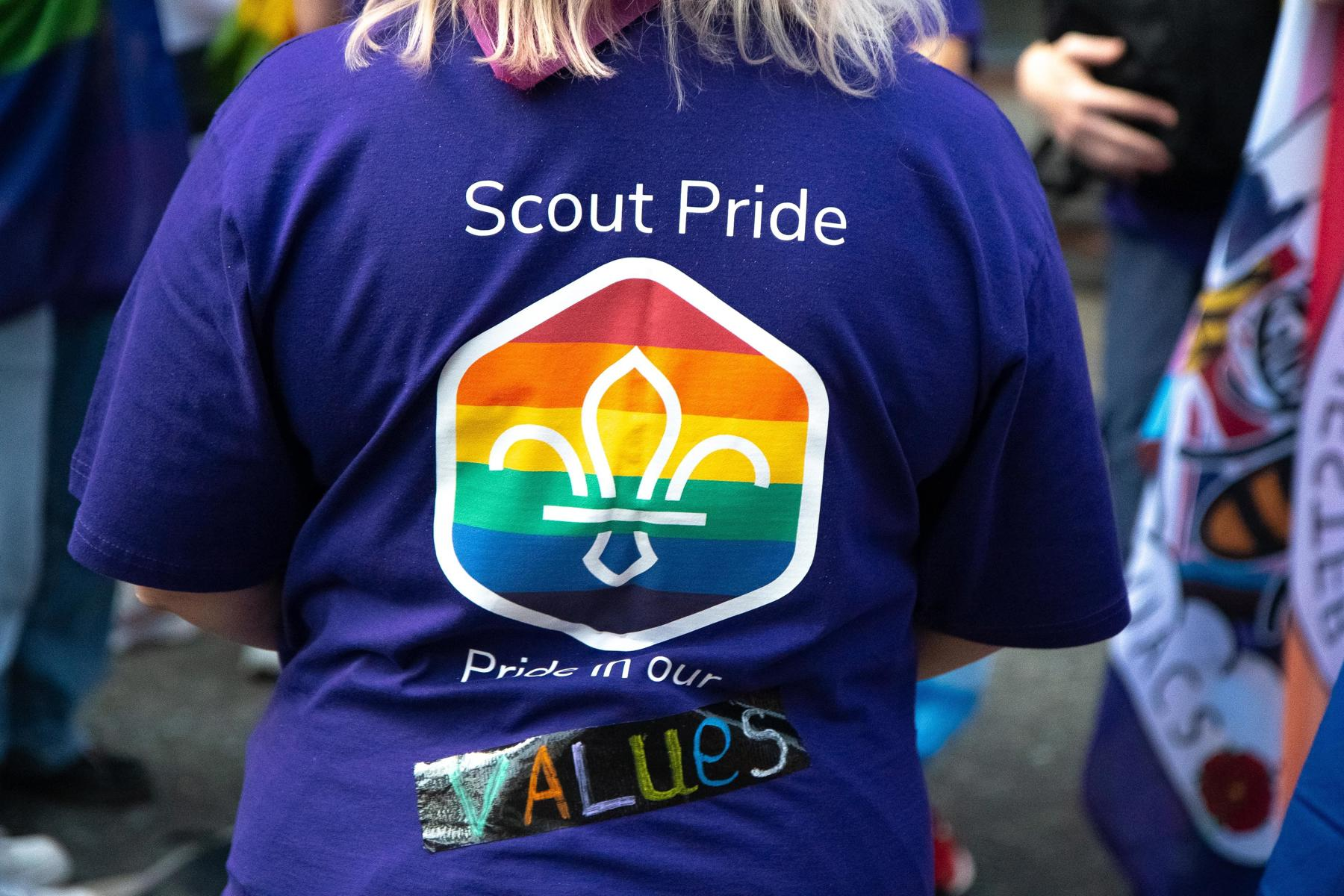 The back of a purple t-shirt with a Scout pride badge print and the text "Scout pride", "Pride in our values"