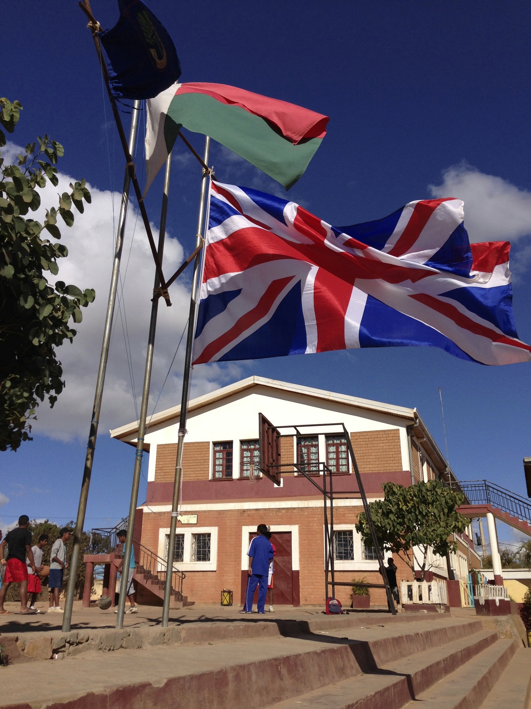 A Malagasy and British flag waving outside a Malagasy Scout hut.