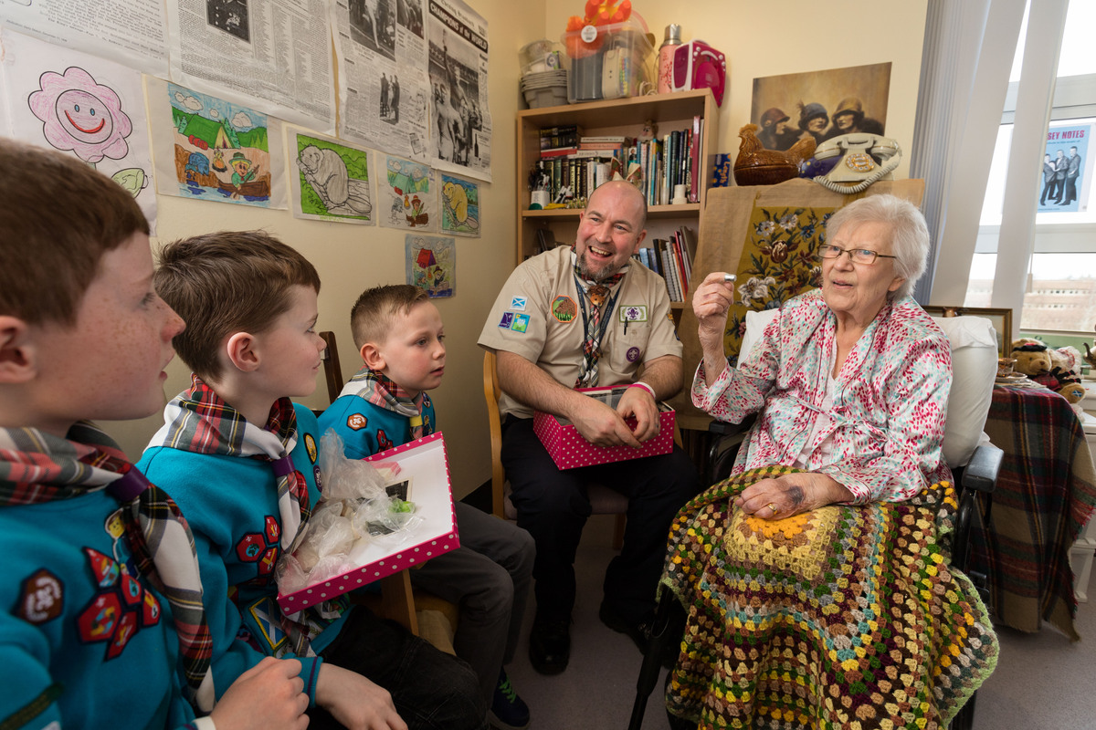 Beavers and leader speaking with lady