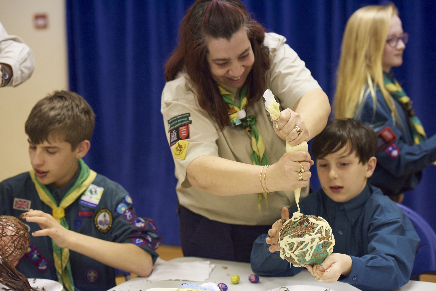 Adult helping Scouts