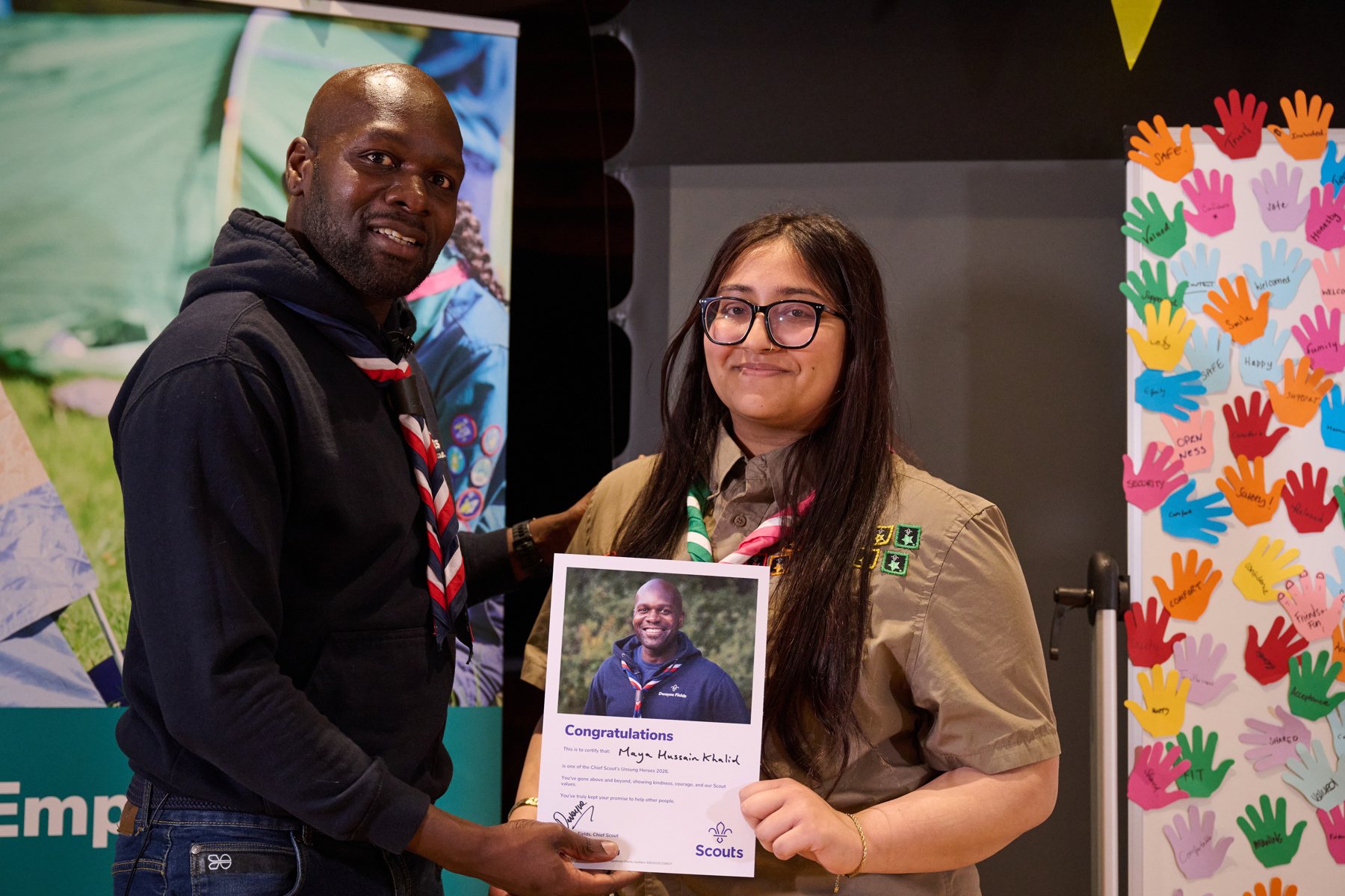 Dwayne Fields presents a certificate to Unsung Hero Maya Hussain Khalid