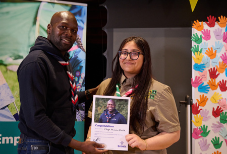 Dwayne Fields presents a certificate to Unsung Hero Maya Hussain Khalid