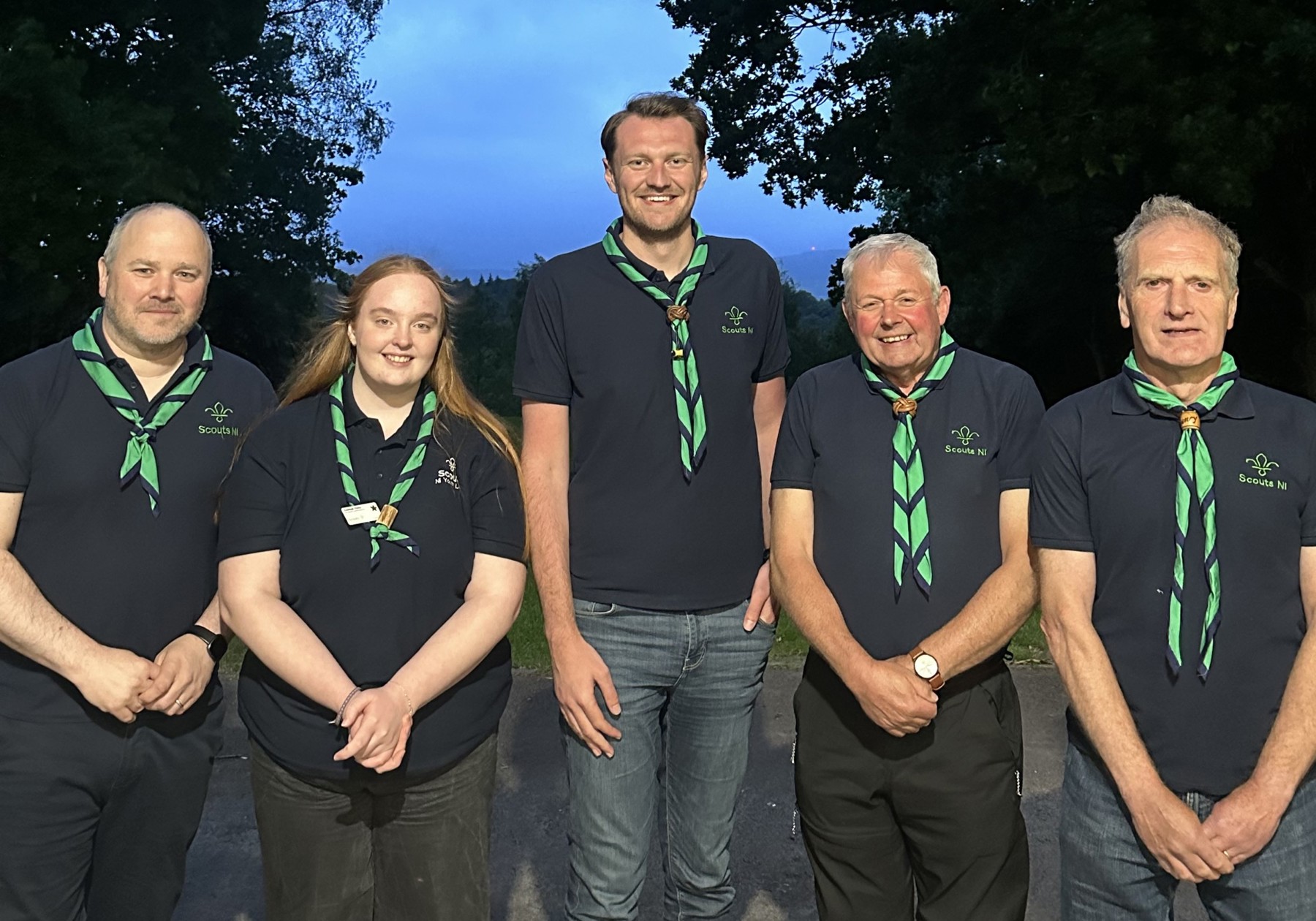 Five members of the Scout NI Team standing outside together with scout scarfs round their necks