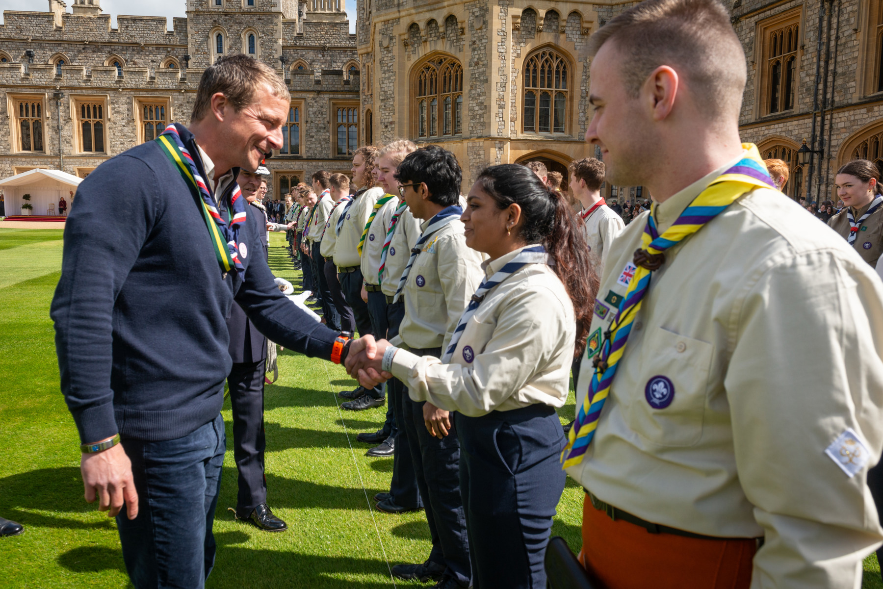 Bear Grylls shakes hands with a Scout at Windsor.
