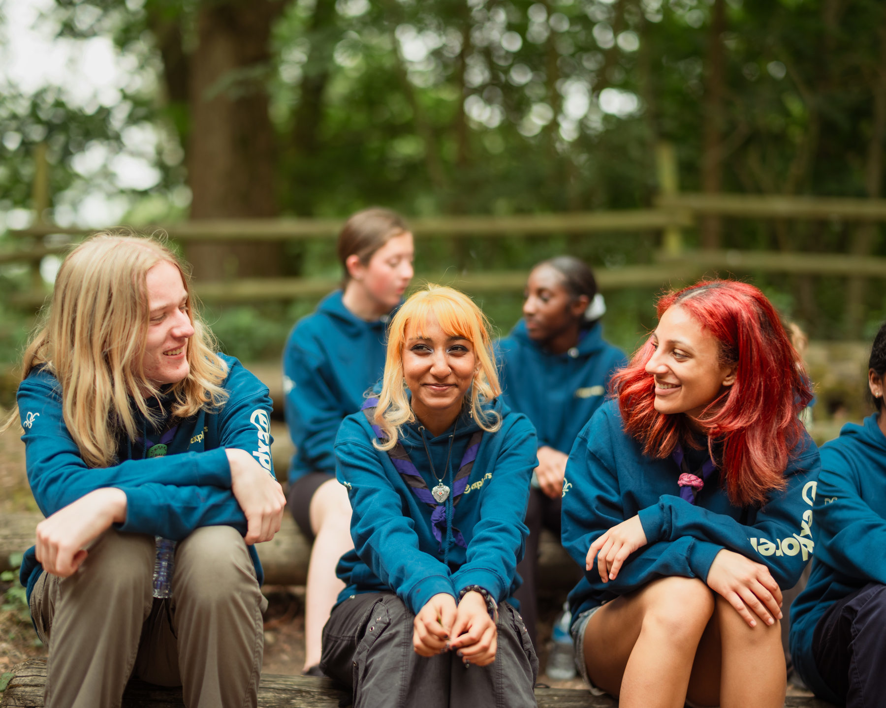 A group of Explorers sit outside.