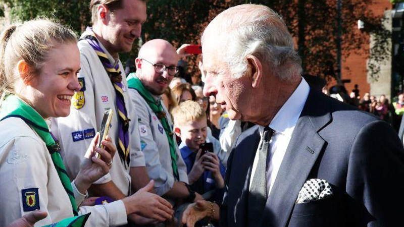 King Charles III congratulating a Scout