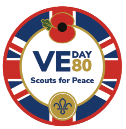 The image shows Scouts' badge for VE Day 80. The badge has a red border with a union jack pattern on the inner edge, then a red poppy at the top in the middle. The text 'VE Day' appears in navy with a gold '80' next to it, with the navy text 'Scouts for peace' underneath. Underneath that text is a blue fleur-de-lis on top of a gold circle.