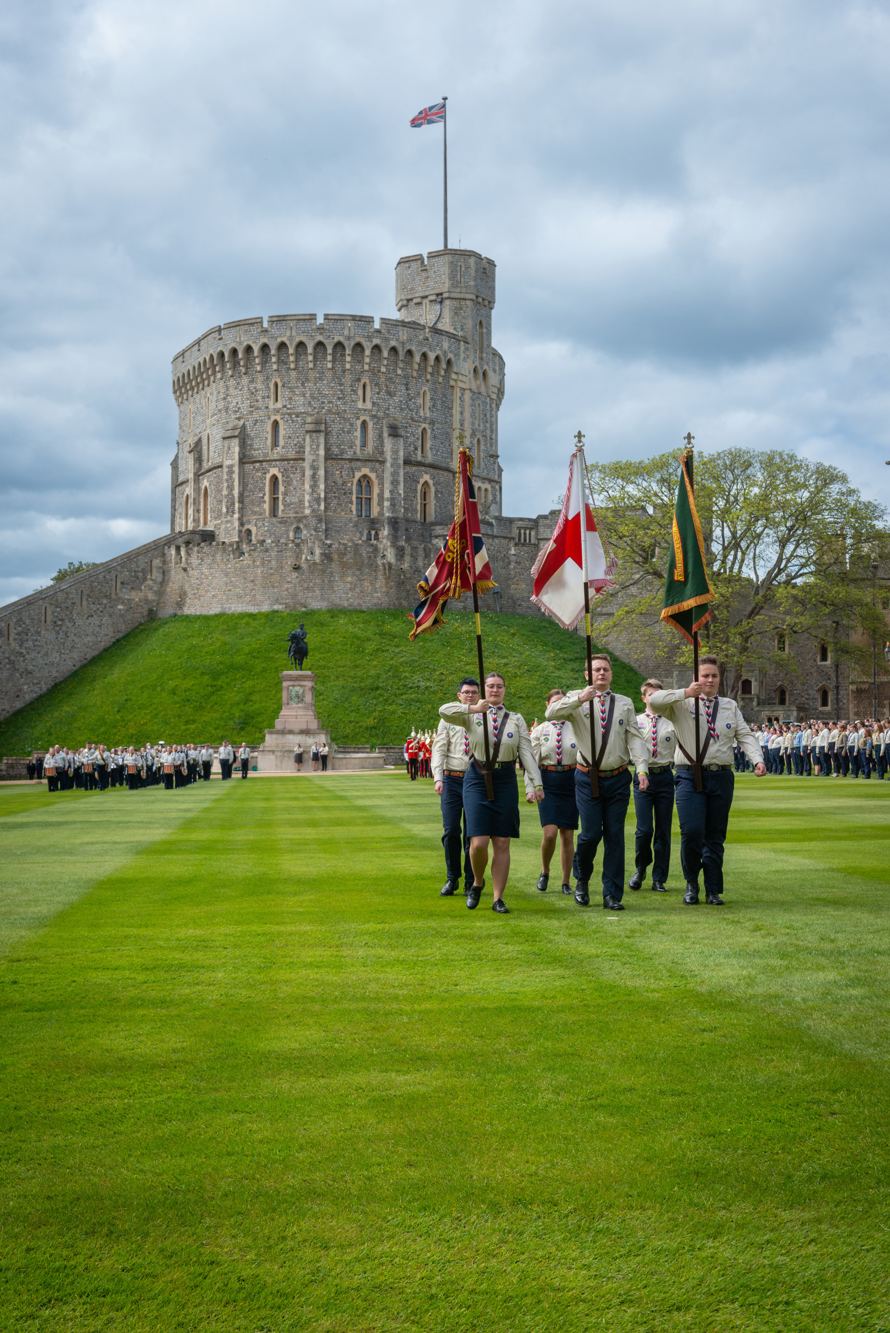 Three volunteers carrying flags at Windsor.