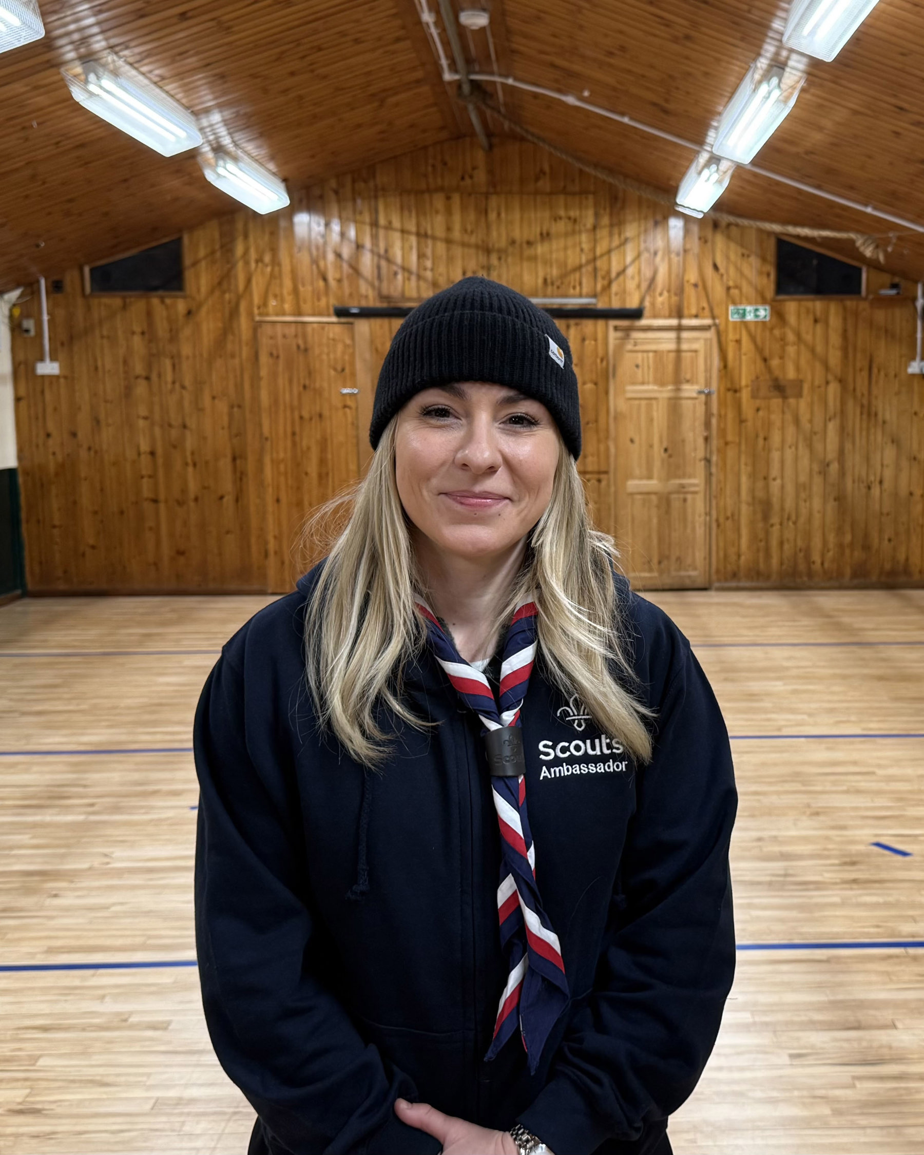 Woman in Scouts neckerchief, hoodie and hat